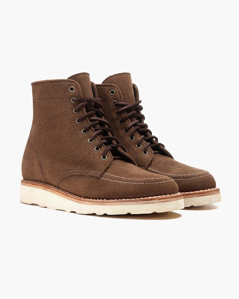 Men's tan ankle-high leather boots with lace-up design and durable buffalo sole.