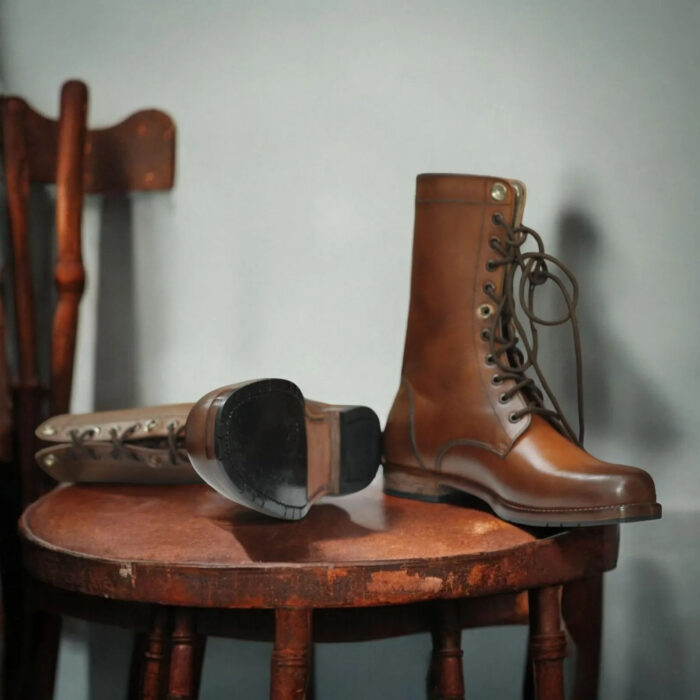 Men's tan ankle-high leather boots with lace-up design and durable buffalo sole.