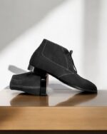 Navy blue suede chukka boots for men with a classic lace-up design.
