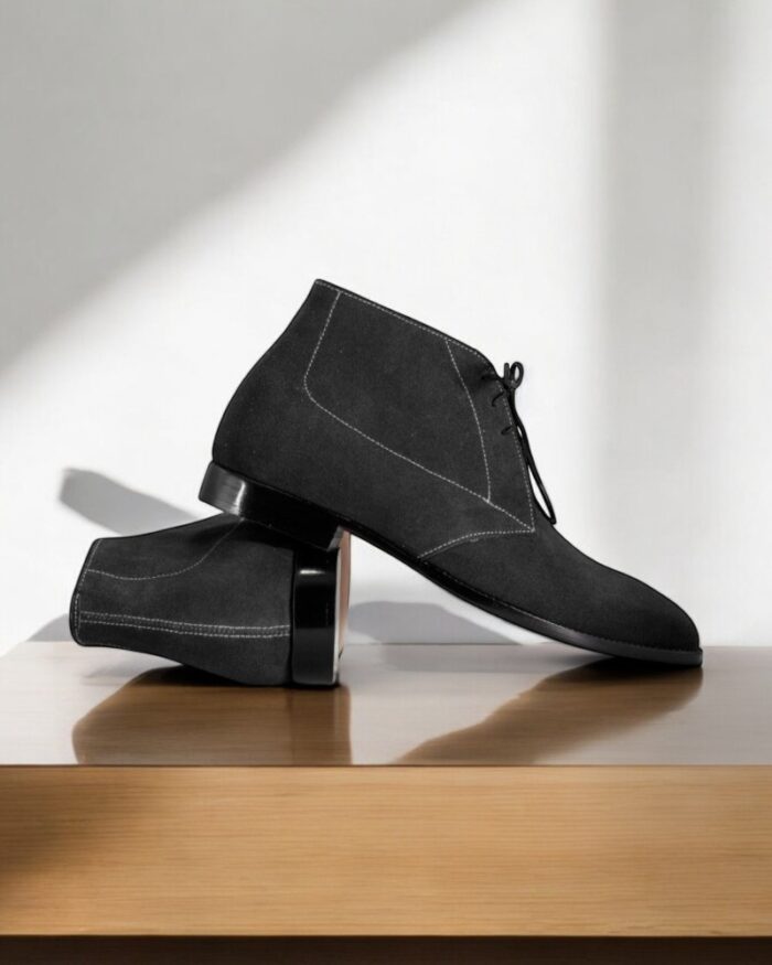 Navy blue suede chukka boots for men with a classic lace-up design.