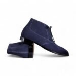 Navy blue suede chukka boots for men with a classic lace-up design.