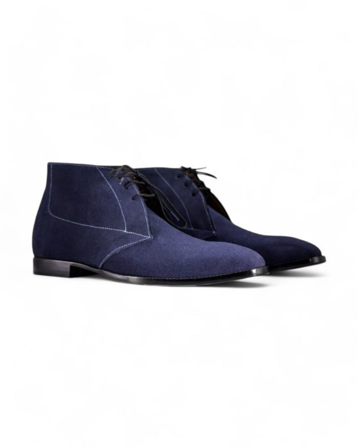 Navy blue suede chukka boots for men with a classic lace-up design.