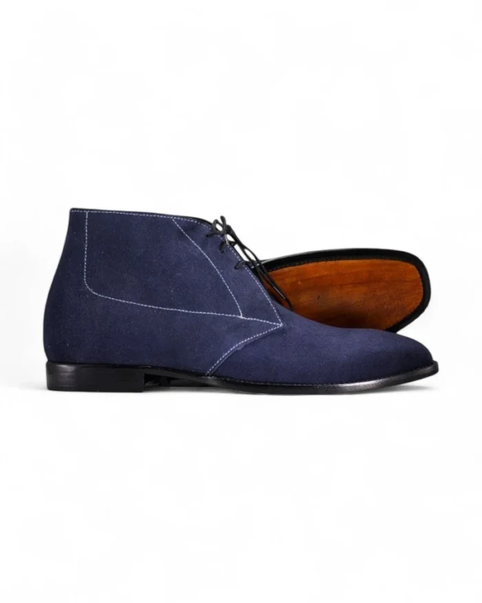 Navy blue suede chukka boots for men with a classic lace-up design.