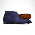 Navy blue suede chukka boots for men with a classic lace-up design.