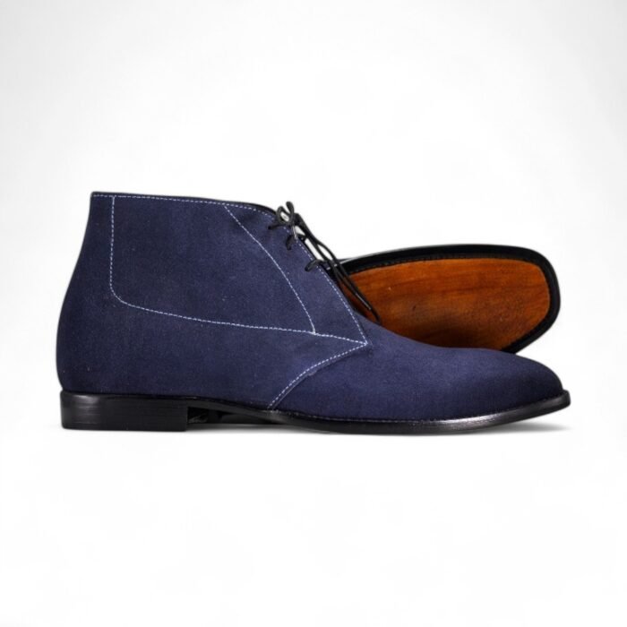 Navy blue suede chukka boots for men with a classic lace-up design.