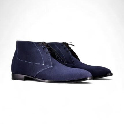 Navy blue suede chukka boots for men with a classic lace-up design.