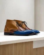 Side profile of Men’s Three-Tone Wingtip Chukka Boots featuring genuine leather construction and classic wingtip detailing.