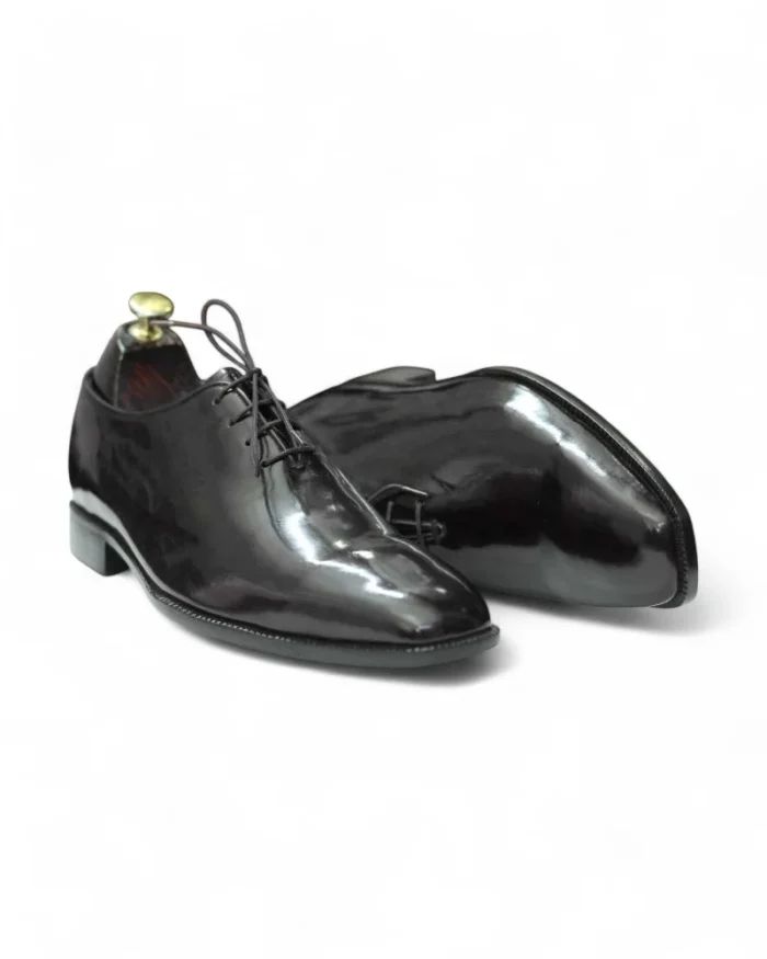 Close-Up of Whole Cut Design on Patent Leather Oxford Shoes